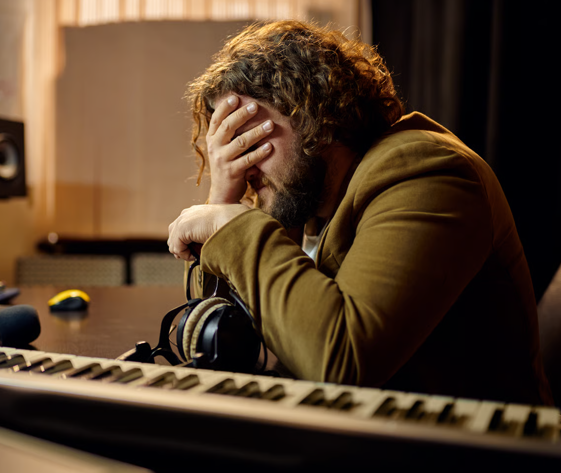 Person frustrated, staring at a screen with just an audio waveform